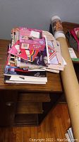 Stack of various books and memorabilia items on a table