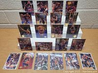 Front view of 18 Phoenix Suns basketball cards arranged on stepped display, showing players in action and glossy card designs.