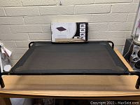 Front view of the assembled Ckaiee pet hammock bed with packaging in background.