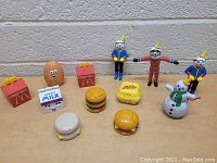 Photo shows full lot including McDonalds food item toys, Jack In The Box clown and astronaut figures, and a snowman figure.