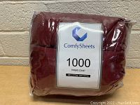 Front view of the new ComfySheets queen sheet set showing the 1000 thread count label and burgundy color.