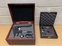 Two wine cork sets in wooden boxes with foam and fabric interiors, showing various cork openers and wine accessories.