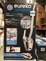 Photo of boxed Eureka Lightspeed NEC160C vacuum showing front and side views, product features, accessories included, and summary specifications.