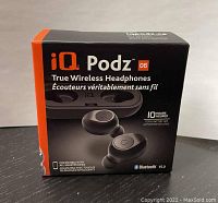 Front of the retail box showing iQ Podz true wireless headphones, branding, 10 hours total battery life, Bluetooth V5.0.