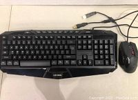 Top view of Lexma LX6000 gaming keyboard and mouse connected with USB cables.