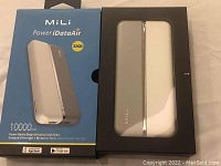 Photo showing the product outside and inside the packaging with a view of the device and box showing key specifications such as 32GB storage and 10,000mAh battery.