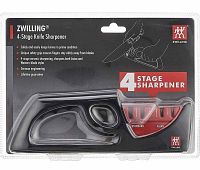 Front view of ZWILLING 4-Stage Knife Sharpener in sealed retail package showing two sharpening slots and safety grip handle.