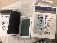Microlife blood pressure monitor in box with manual and one cuff, showing product details on box.