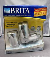 Front view of new Brita Faucet Filtration System in original packaging showing system and included two filters.