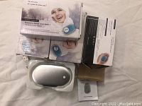 Four boxed hand warmer powerbank units, user guides, and one device in plastic casing.