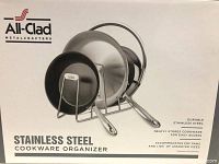 Box showing All-Clad stainless steel cookware organizer with images of the rack holding pans and lids.