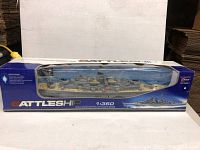 Full view of radio control battleship in original windowed box showing ship model and packaging details.