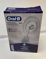 Front view of the retail box showing Oral-B Professional by Braun 3D White Precision 1000 rechargeable toothbrush with whitening and superior cleaning features