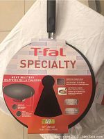 T-fal Specialty Tawa pan front label showing brand, heat mastery claims, pan size (12" / 30 cm), and non-stick features.