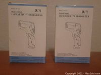 Photo showing two boxed KAIYI infrared thermometers side by side, labeled model KY-111
