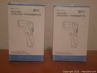 Two boxed KAIYI Infrared Thermometers in their original packaging, front view.