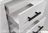 Handle installed on a white cabinet drawer showing size and appearance in use.