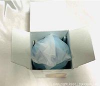 Mini USB bottle humidifier wrapped in plastic inside its open white box.