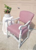 Side angled photo showing the newly refinished antique wooden chair with red and grey herringbone upholstered seat and backrest. The chair's grey painted frame and detailed legs with carved apron are visible.