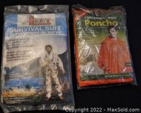 Photo of new sealed alert brand survival suit and lightweight poncho in packaging.