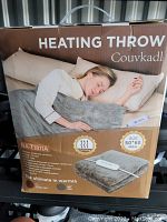 Boxed Couvkadl heating throw size 50x60 inch grey color with remote control shown on package front and side