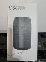 Front of the boxed M68 Portable Speaker showing the product image and model name.