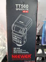 Neewer TT560 Speedlite flash box front showing product image, model, and user guide text