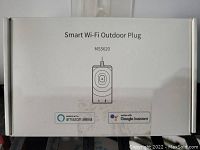 Image of the front side of the box labeling the product as Smart Wi-Fi Outdoor Plug MSS620 showing compatibility with Amazon Alexa and Google Assistant.