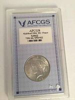 Front view of the slabbed 1922 US Peace Dollar graded MS62 by AFCGS showing Lady Liberty head design with grading label.