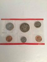 Obverse side of two sealed 1983 US Mint coin sleeves showing Lincoln cent, Jefferson nickel, Roosevelt dime, Washington quarter, Kennedy half dollar, Eisenhower dollar
