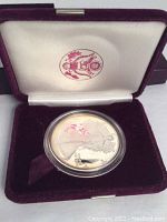 Obverse of the coin inside the velvet display case showing Walking Liberty design.