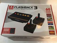 Photo of the Atari Flashback 3 console box showing front face with images of the console, two joysticks and game titles