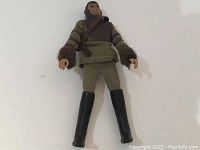 Front view of Cornelius figure standing, showing clothing details and sculpted face