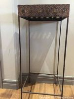 Full view of metal hall table showing square top with hammered texture and slender straight legs.