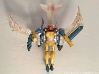 Front view of the Transformers Beast Wars Airazor action figure showing wings extended, humanoid robot form with gold and blue color scheme and detailed purple and white wings.