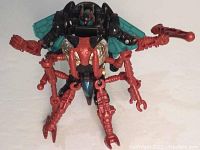 Front view of the Waspinator figure, showing detailed red limbs and teal wings spread, with mechanical body and blue details.