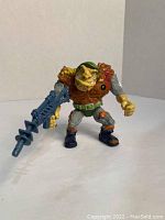 Front view of General Tragg action figure holding blue weapon, showing figure details