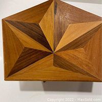 Top-down view showing the geometric marquetry wood pattern on the surface