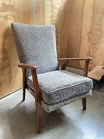 Front view of chair showing full upholstery and wooden frame