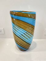 Front view of amber and turquoise swirl glass vase