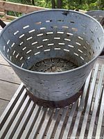 Top down view of the perforated aluminum bucket showing the inside and ventilation holes.