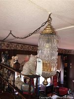 Hanging lamp suspended from ceiling showing overall design and environment.