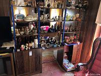 Full view of wood shelving unit with various decorative items on shelves.