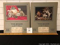 Both 1938 sample calendars together, showing cat and dog images, calendar months, and advertising text