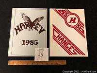 Two yearbooks from George Harvey Collegiate Institute from years 1985 and 1986 placed side by side showing front covers.