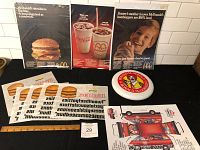 Photo showing all items including three vintage McDonald's ads, iron-on transfers, frisbee, and toy van