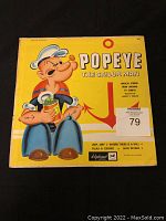 Yellow sleeve with Popeye illustration, showing wear and creases.