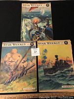 Photo showing three Star Weekly magazines, April-July 1944 issues, covers depict wartime combat scenes: naval gunfire, aerial dogfight, and battleship at sea.