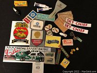 Overview of all items laid out including stickers, patches, pins, spark plug and small advertising pieces