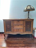 Full front view of beechwood server with three drawers and caned cupboard doors